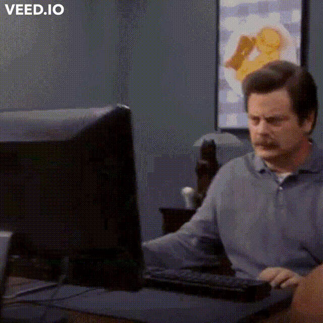 person throwing computer into trash can
